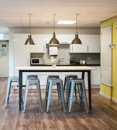 An office with a grey couch.