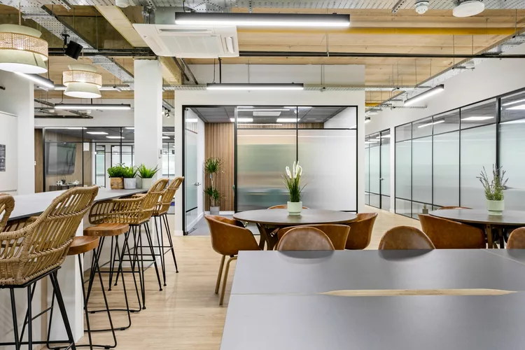 Coworking Space at Venaspace in Plymouth with black round tables and brown leather chairs