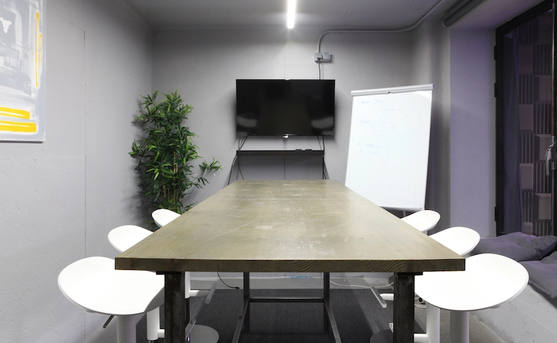 6 seat meeting room with a whiteboard and a screen at La Vaca Coworking - on Tally Maket.jpg