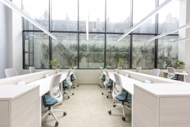 Hot desk area with large windown wall at Queen Mary University Enterprise Zone - On Tally Market.jpg