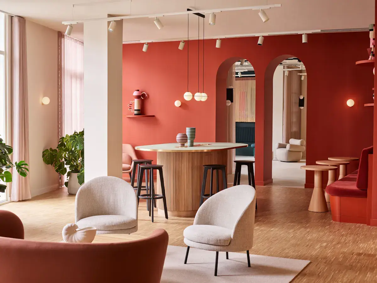 Coworking area at FORA Liberty House with red painted walls and two grey chairs 