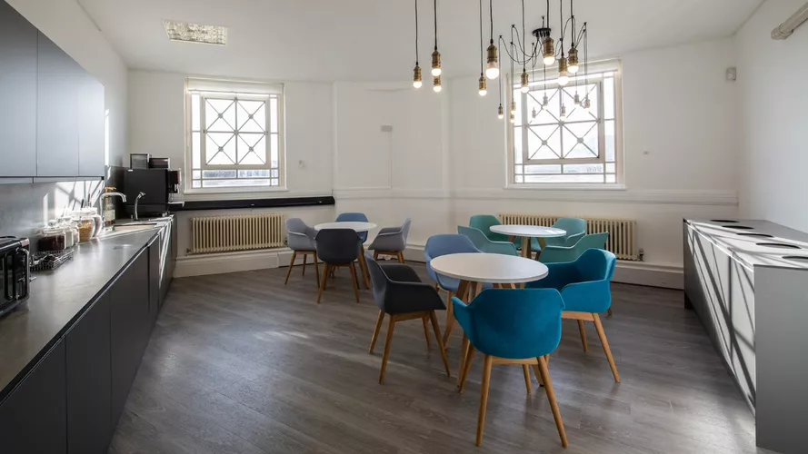 Coworking and dining space next to a kitchen in Boutique Wimbledon Old Town Hall office space