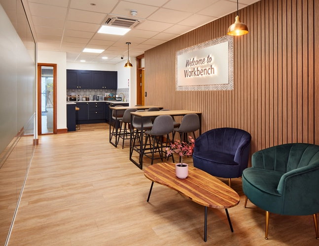 Breakout Space and Kitchen at 6 Ocean Way Offices in Cardiff showcasing a green couch and a navy blue couch 