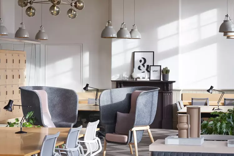 Office Space at FORA East Side with two grey chairs and dusty pink pillows