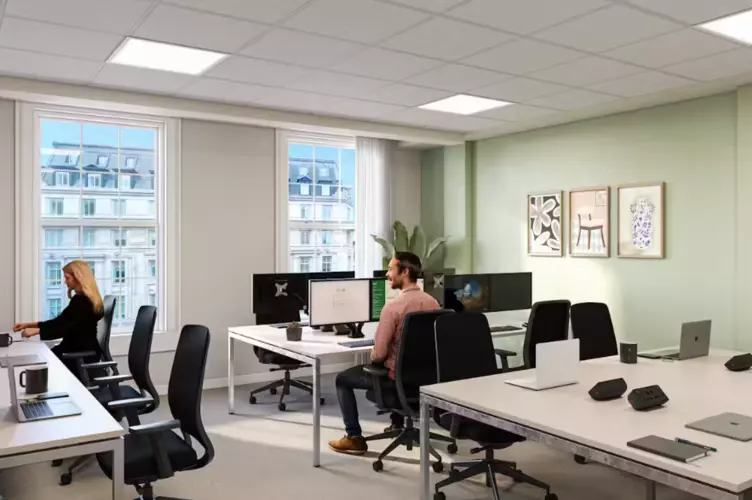 An office with black chairs and white tables.