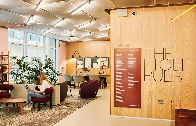 Co-working and breakout space with large meeting room table at The Light Bulb Workspace