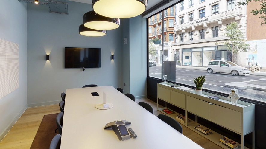 Meeting room at TOG The Smiths Building with light blue wall and large window with street view of London 