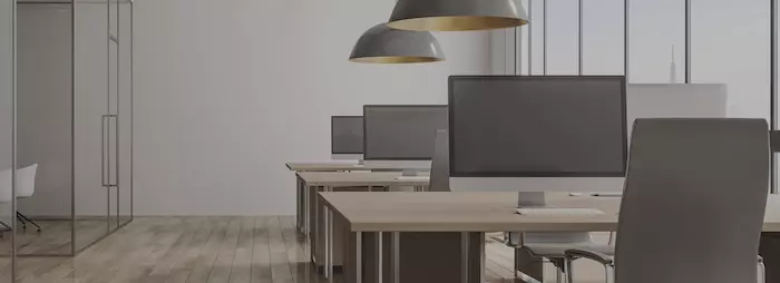The coworking area at PODZ.WORK, equipped with second screens.