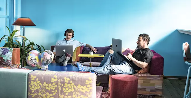 breakout lounge at Blivande showing a sofa against a bright blue wall