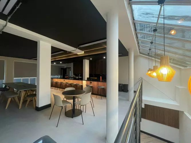 Kitchen and breakout area at House of Creative with large sky lights and breakfast bar seating 