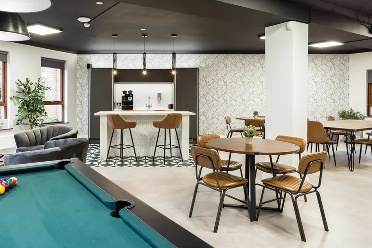 Kitchen Space and breakout area at Venaspace Bournemouth with a pool table, white kitchen island with brown leather chairs