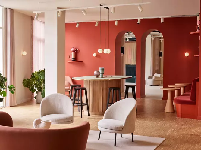 Coworking area at FORA Liberty House with red painted walls and two grey chairs 
