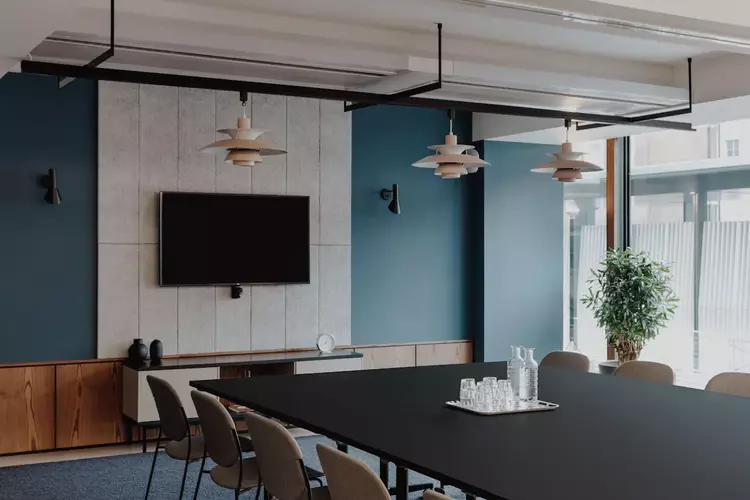 Meeting room at FORA 20 Eastbourne Terrace office space a blue wall and a mounted TV