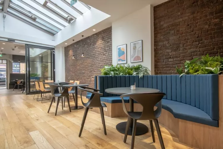 Lentaspace Blackfriars Road breakout space with exposed brick wall and blue booth style seating 
